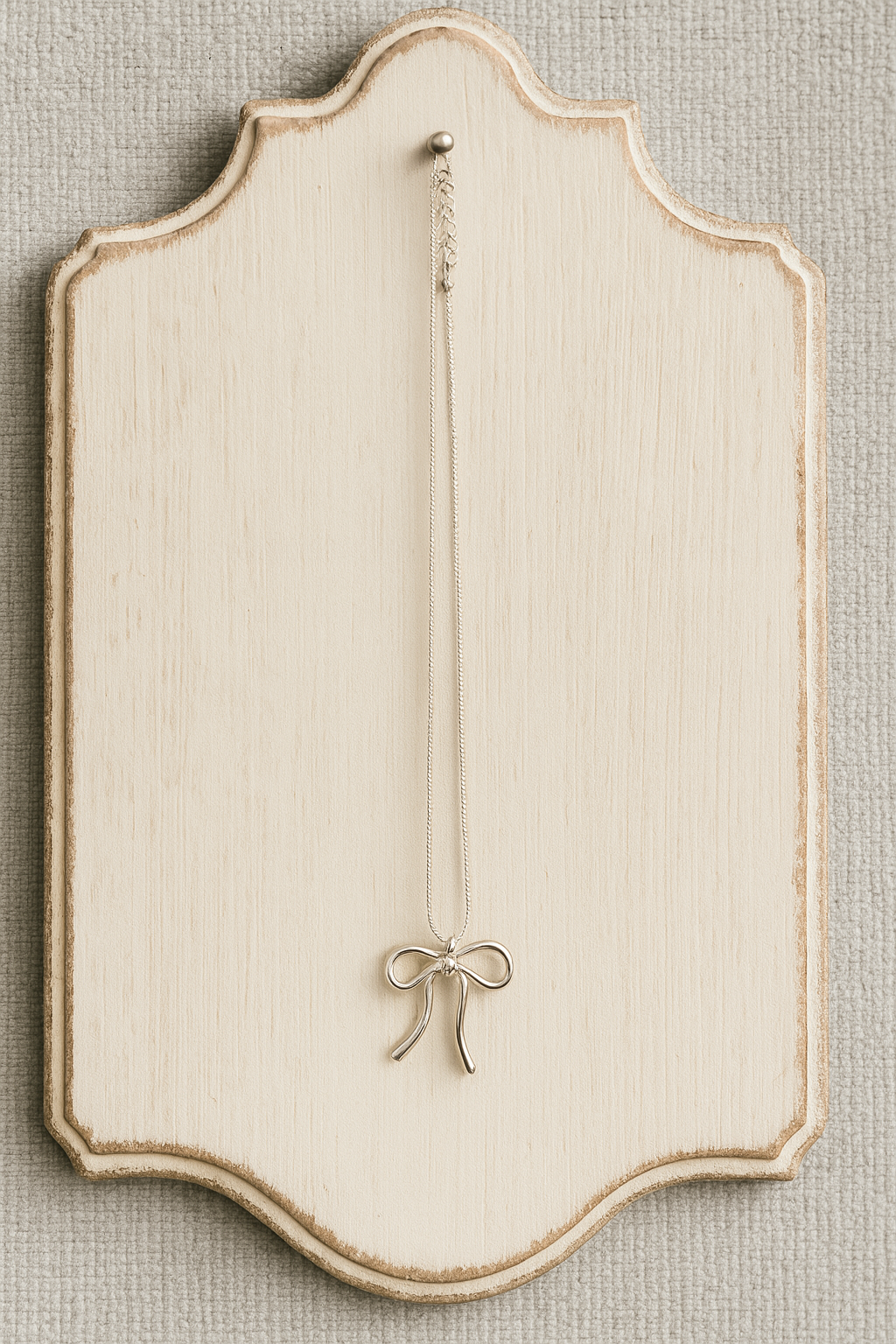 Elegant Charm: The Silver Bow Necklace
